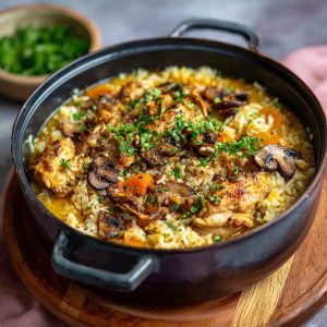 One-pot coconut chicken brothy rice served warm in a bowl, cozy dinner with creamy broth and tender chicken.