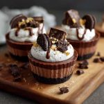 Oreo chocolate mousse cups layered with crushed Oreos, creamy chocolate mousse, and whipped topping in a glass.