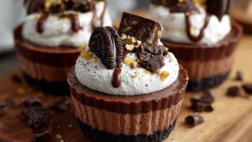 Oreo chocolate mousse cups layered with crushed Oreos, creamy chocolate mousse, and whipped topping in a glass.