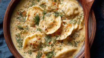 Creamy dill pierogi soup with tender dumplings, fresh dill, and a rich broth served in a cozy bowl.
