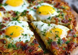 “A golden breakfast pizza with a crispy hash brown crust, topped with eggs, cheese, and breakfast toppings.”
