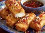 Golden oven-fried feta rolls drizzled with spicy chili honey, crispy appetizer with a sweet-heat kick.