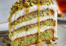 Elegant pistachio mascarpone layer cake with fluffy sponge, creamy mascarpone frosting, and crushed pistachio topping.
