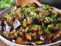 Sautéed Chinese eggplant in garlic sauce, tender eggplant pieces coated in savory, glossy sauce with sesame seeds and scallions.