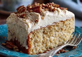 Butter pecan tres leches cake topped with whipped cream, caramel drizzle, and crunchy pecans, served moist and decadent.