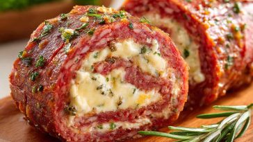 “Thin slices of salami rolled with cream cheese and herbs, arranged neatly on a serving platter.”