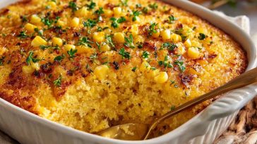 Golden honey glazed corn casserole baked to perfection, with a sweet glaze and fluffy texture served in a rustic dish.
