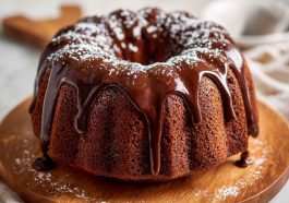 Slice of Mexican chocolate milk cake topped with chocolate drizzle and cinnamon.
