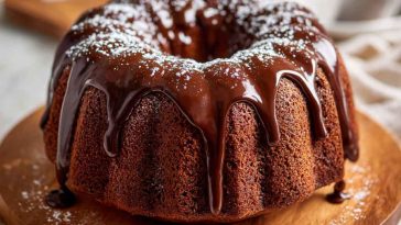 Slice of Mexican chocolate milk cake topped with chocolate drizzle and cinnamon.