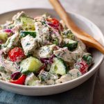 "Fresh tzatziki chicken salad served in a bowl with cucumbers, herbs, and creamy Greek yogurt dressing."