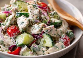 "Fresh tzatziki chicken salad served in a bowl with cucumbers, herbs, and creamy Greek yogurt dressing."