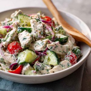 "Fresh tzatziki chicken salad served in a bowl with cucumbers, herbs, and creamy Greek yogurt dressing."