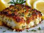 "Garlic parmesan crusted halibut fillet baked golden brown, topped with fresh herbs and served with lemon wedges."