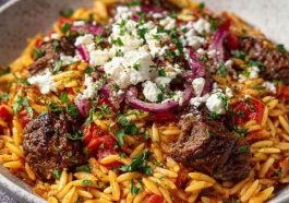 “A traditional Greek beef giouvetsi with tender beef, orzo pasta, rich tomato sauce, and sprinkled cheese.”