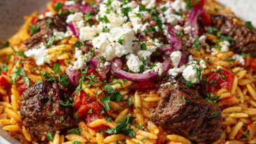 “A traditional Greek beef giouvetsi with tender beef, orzo pasta, rich tomato sauce, and sprinkled cheese.”