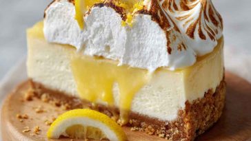 Triple lemon meringue cheesecake with golden crust, creamy lemon filling, and fluffy toasted meringue topping.