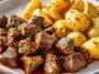 Slow cooker garlic butter beef bites with tender potatoes, garnished with fresh parsley and served in a rustic dish.