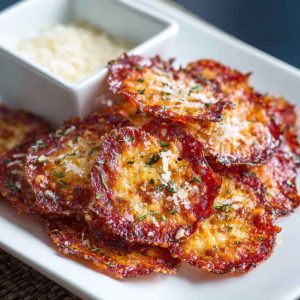 "Crispy baked pepperoni and cheese crisps served on a tray, golden and crunchy with melted cheese."