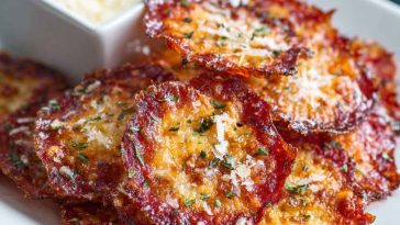 "Crispy baked pepperoni and cheese crisps served on a tray, golden and crunchy with melted cheese."