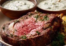 “A creamy bowl of Ina Garten’s horseradish sauce served alongside slices of prime rib roast.”