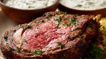 “A creamy bowl of Ina Garten’s horseradish sauce served alongside slices of prime rib roast.”