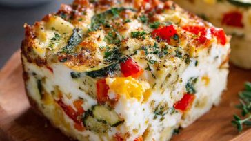 “A golden baked cottage cheese and veggie casserole filled with colorful vegetables, creamy cheese, and herbs.”