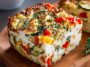 “A golden baked cottage cheese and veggie casserole filled with colorful vegetables, creamy cheese, and herbs.”