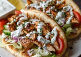 “Warm pita bread filled with juicy Mediterranean chicken gyros, fresh vegetables, and creamy tzatziki sauce.”