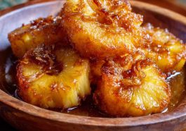 Golden rum-soaked fried pineapple rings caramelized to perfection, topped with a drizzle of syrup and mint garnish.