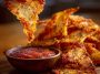 Crispy homemade pizza chips topped with melted cheese, herbs, and pepperoni slices, served as a crunchy snack.