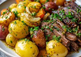 A hearty slow cooker dish with tender garlic butter beef and golden potatoes, garnished with fresh herbs.