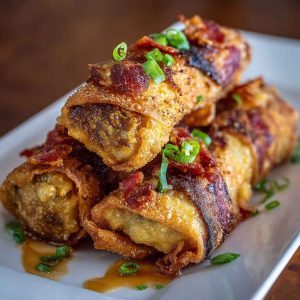 “Crispy golden voodoo egg rolls filled with spicy chicken, peppers, and cheese, served with dipping sauce.”