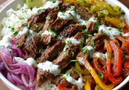 “A colorful steak fajita bowl with grilled steak strips, sautéed peppers, onions, avocado, and cauliflower rice.”