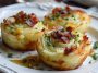 Golden mashed potato nests stuffed with melted cheese and garnished with fresh herbs.