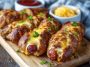 Soft baked cheesy pretzel dogs wrapped in golden pretzel dough, stuffed with melted cheese and hot dogs, served warm with dipping sauce.