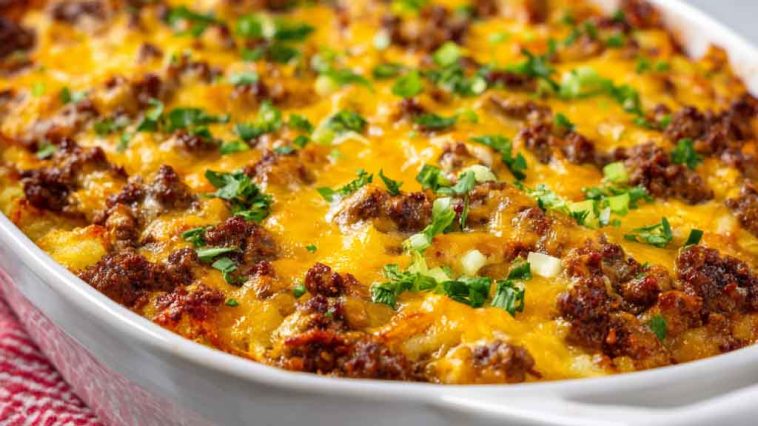 "Hearty hobo casserole made with ground beef, potatoes, cheese, and vegetables baked golden in a casserole dish."