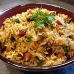Jailhouse rice served in a skillet with ground beef, sausage, rice, and savory seasonings, garnished with fresh parsley for a hearty one-pot meal.