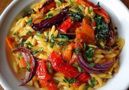 Roasted vegetable orzo served in a bowl, featuring golden roasted zucchini, bell peppers, cherry tomatoes, and tender orzo pasta tossed with olive oil and fresh herbs.