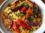 Roasted vegetable orzo served in a bowl, featuring golden roasted zucchini, bell peppers, cherry tomatoes, and tender orzo pasta tossed with olive oil and fresh herbs.
