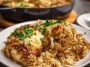 One-pot French onion chicken rice dinner cooked in a skillet, featuring tender chicken, caramelized onions, melted cheese, and fluffy rice garnished with fresh herbs.