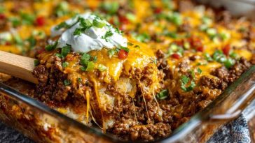 Hobo casserole ground beef recipe baked in a casserole dish with layers of seasoned ground beef, potatoes, vegetables, and melted cheese, served golden brown and hearty.