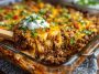 Hobo casserole ground beef recipe baked in a casserole dish with layers of seasoned ground beef, potatoes, vegetables, and melted cheese, served golden brown and hearty.