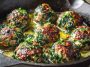 Easy spinach and garlic meatballs served on a plate with marinara sauce, garnished with fresh parsley and Parmesan cheese.