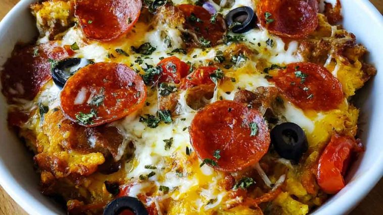 Low carb crustless pizza bowl with melted cheese, pepperoni, and fresh herbs in a dish.