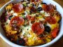 Low carb crustless pizza bowl with melted cheese, pepperoni, and fresh herbs in a dish.