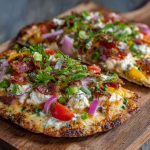Cottage cheese flatbread pizza topped with melted cheese, tomato sauce, and fresh basil.