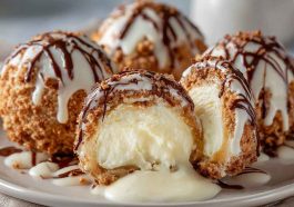Delicious Italian cream bombs dusted with powdered sugar, filled with rich cream, and served on a rustic wooden board with espresso.