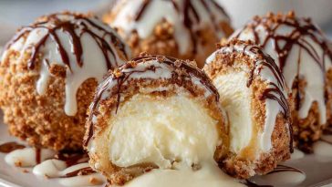 Delicious Italian cream bombs dusted with powdered sugar, filled with rich cream, and served on a rustic wooden board with espresso.