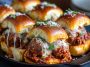 Cheesy pull-apart meatball sliders baked on soft Hawaiian rolls with marinara and melted mozzarella