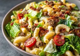 Big Mac Pasta Salad with ground beef, cheddar cheese, lettuce, pickles, and creamy special sauce in a colorful bowl.